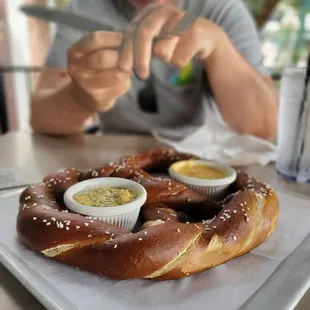 a man cutting a pretzel