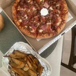 Meat lovers pizza and potato wedges