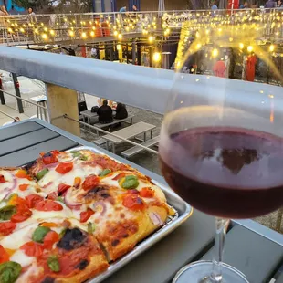 a pizza and a glass of wine