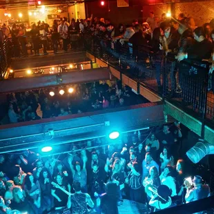 a crowd of people dancing at a nightclub