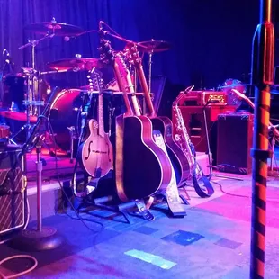 a stage with guitars and amps