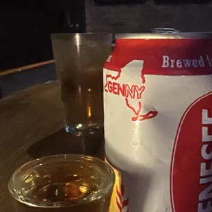 a glass of beer and a can of beer