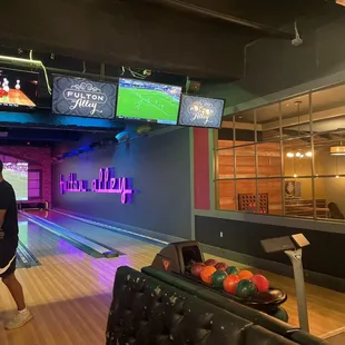 a man standing in front of a bowling alley