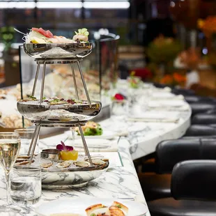 three tiered trays of food on a table