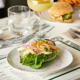 a plate of food and a glass of wine