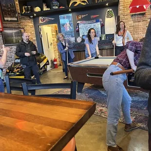 a group of people playing pool