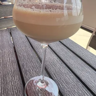 a glass of coffee on a table