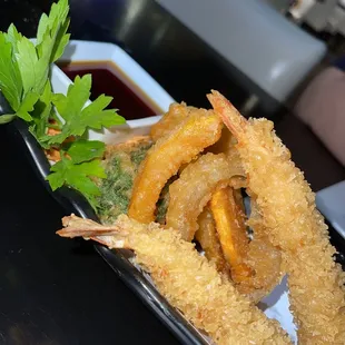 a deep fried shrimp and onion rings