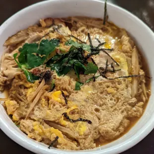 a bowl of ramen with meat and vegetables