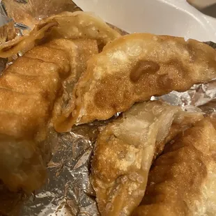 fried dumplings in a styrofoam container
