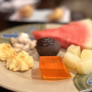 a plate of fruit and sweets