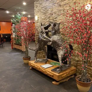 a stone fireplace with red flowers