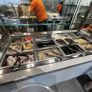 a man in an orange shirt preparing food