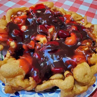Funnel cake with chocolate sauce and strawberry topping