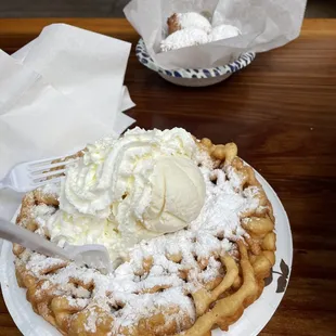 funnel cake with powdered sugar and vanilla ice cream