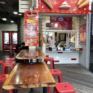 a wooden table and red chairs