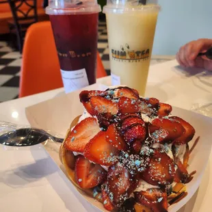 a waffle with strawberries and powdered sugar
