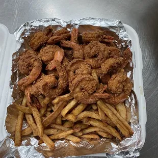 a tray of fried shrimp and french fries