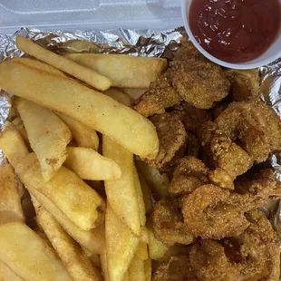 fried chicken and french fries in a styrofoam container