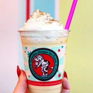 a hand holding a cup