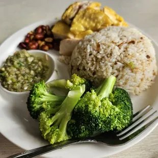 a plate of food with rice, broccoli and beans