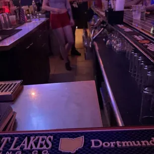 a woman standing at the bar
