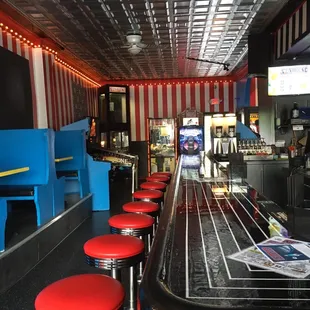 a row of red stools at a bar