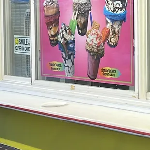 an ice cream shop window with ice cream cones