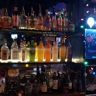 a bar with a lot of bottles of alcohol