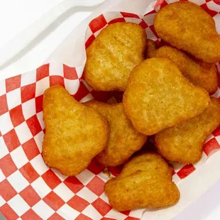 a basket of fried fish and chicken nuggies