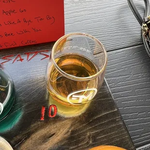 a glass of beer and a note