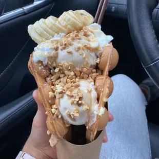Chunky Monkey! Butter Pecan ice cream, topped with caramel, peanuts, banana and chocolate pocky on a cake-like waffle cone!
