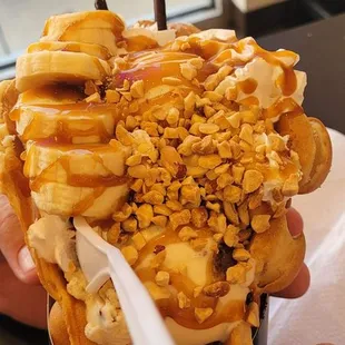 a person holding a cup of ice cream