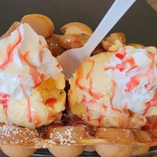 a waffle topped with whipped cream and fruit
