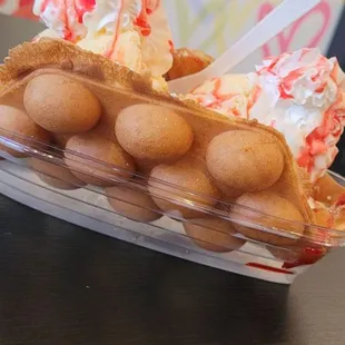 a waffle with whipped cream and sprinkles