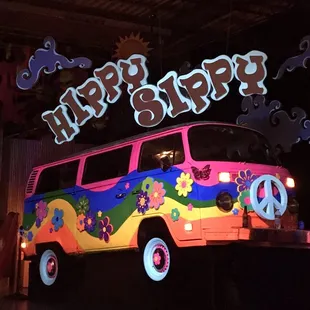 a hippie van decorated with flowers and peace signs