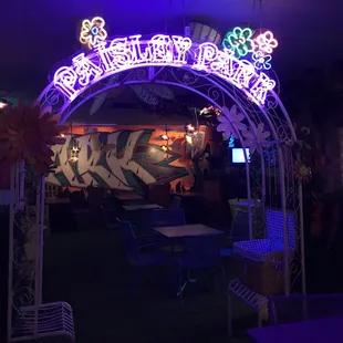 a neon sign in the middle of a restaurant