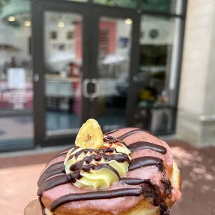 a hand holding a donut