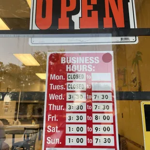 a business hours and hours sign