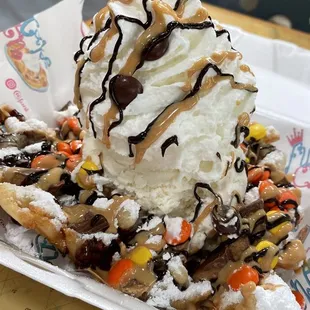 Reese&apos;s Lovers | Classic funnel cake w ice cream, whipped cream, Reese&apos;s cups, Reese&apos;s pieces, peanut butter, chocolate drizzles