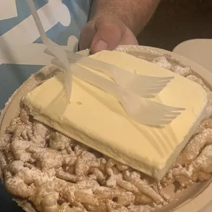 Regular funnel cake with powdered sugar and ice cream