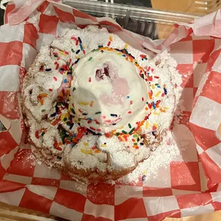 a doughnut with sprinkles and powdered sugar