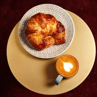 a croissant and a cup of coffee