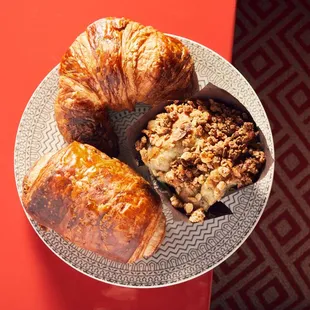 a plate of pastries and croissants