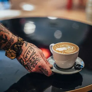 a person holding a cup of coffee