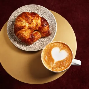 a croissant and a cup of coffee
