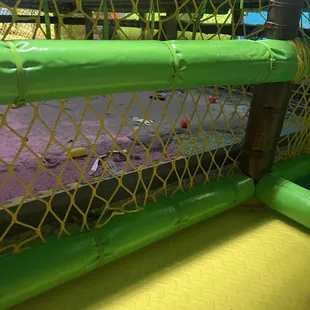 Area under the trampoline, adjoining play area with  swings, slides, etc.