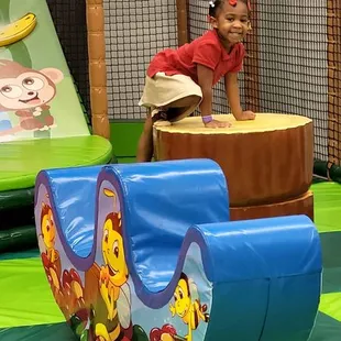 a toddler playing on a slide