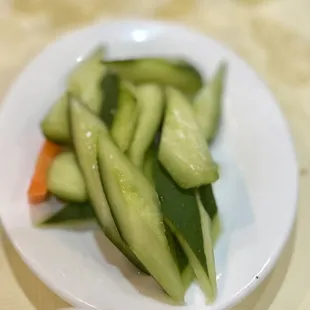 a plate of cucumbers and carrots