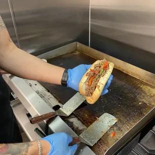 a person cutting a sandwich